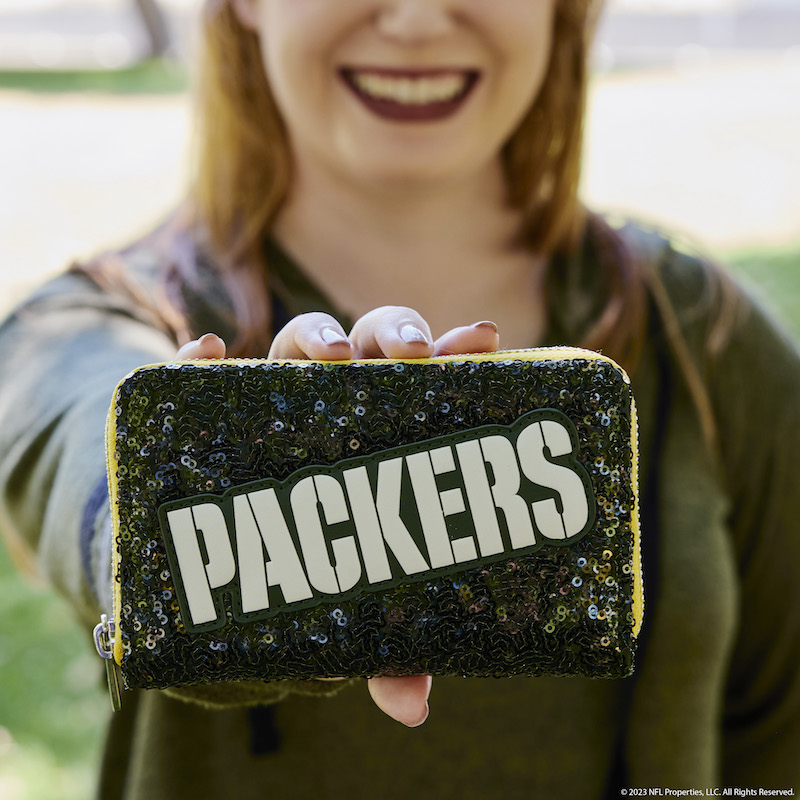 Image of woman holding the NFL Green Bay Packers Sequin Wallet out to the camera 